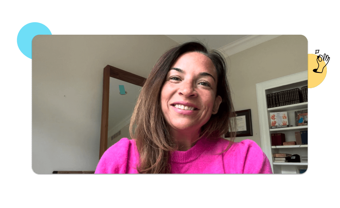 Amy Nelson smiles for the camera from her home office.